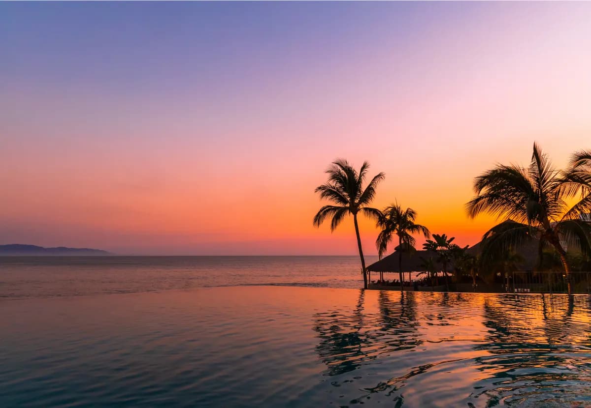 Fitness center with modern equipment and panoramic floor-to-ceiling jungle views