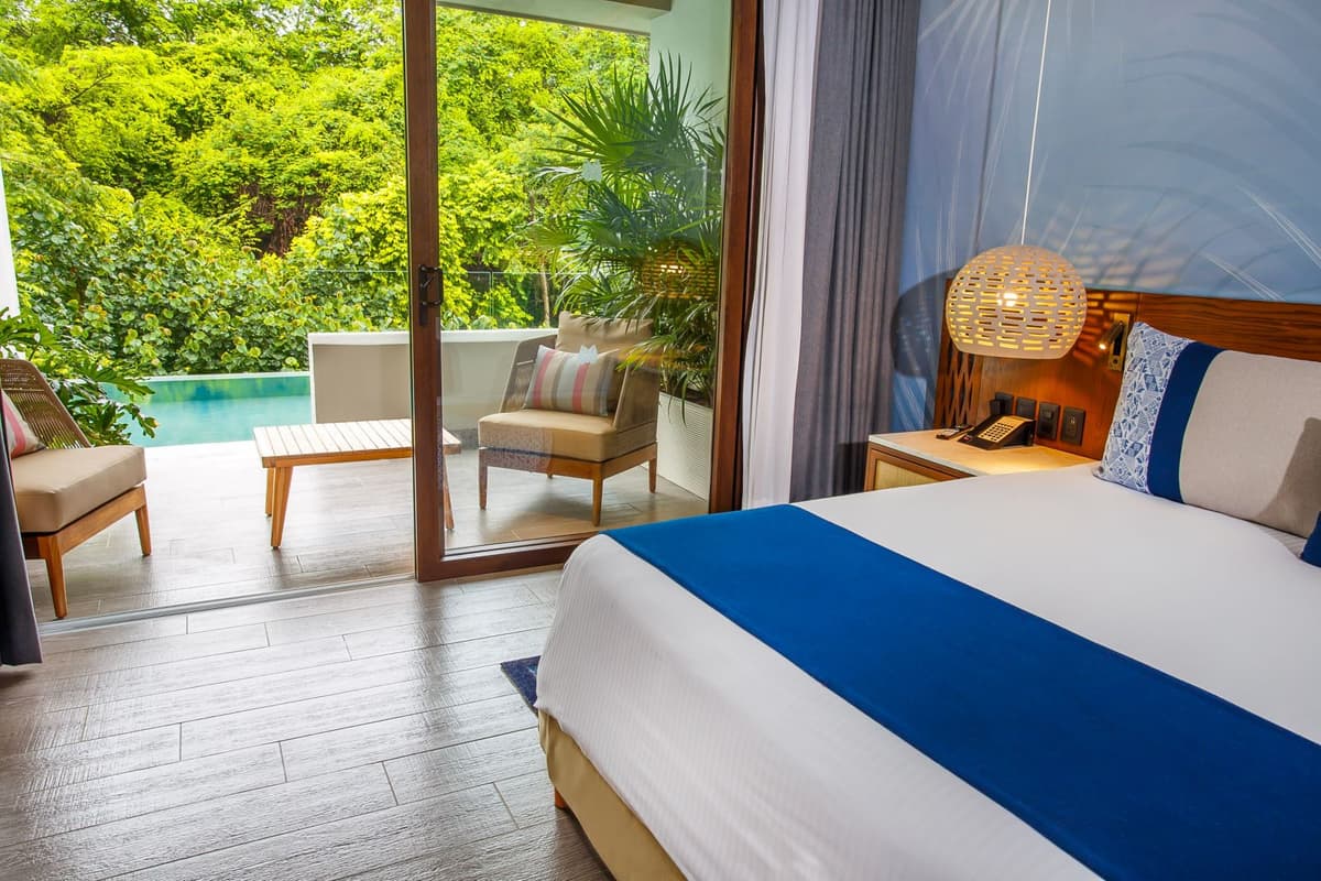 Swim-out suite with private plunge pool, jungle views, and modern tropical decor