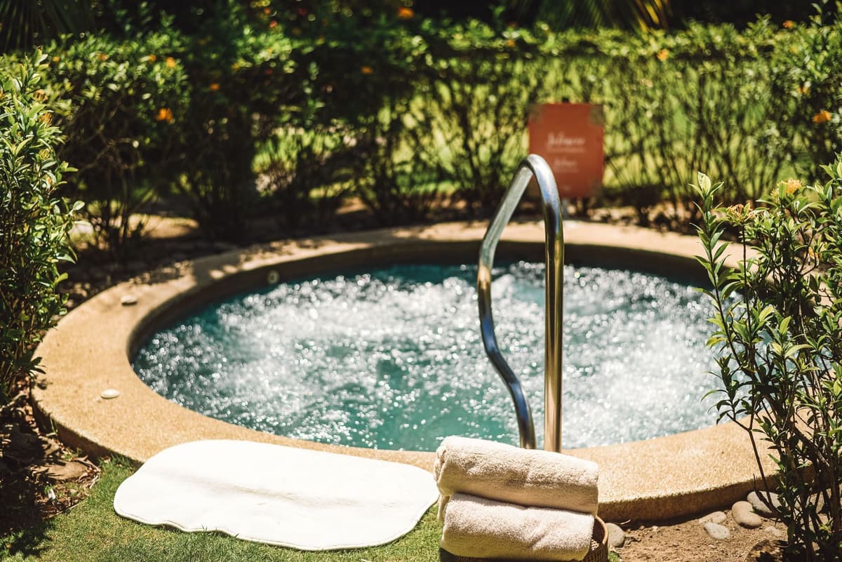 Heliconia Spa treatment bungalow interior with massage table and tropical garden views