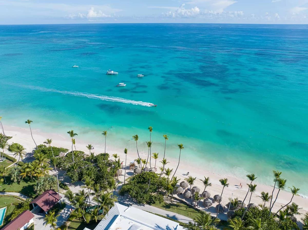 Aerial view of the Grand Palladium Punta Cana complex showing tropical grounds, pools, and Bavaro Beach coastline