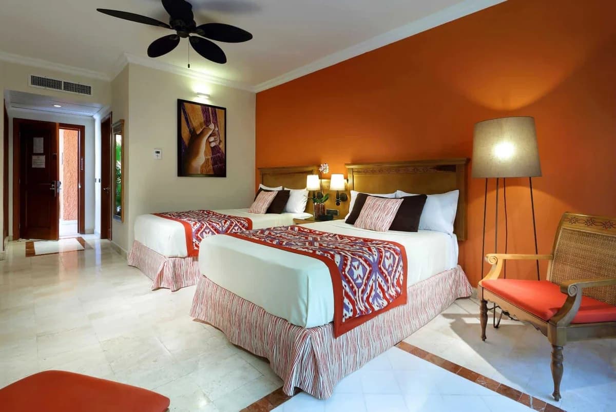 Deluxe Garden View room second angle showing the seating area and garden-view balcony