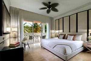 Suite Garden View with separate living room, marble and wood finishes, terrace, and tropical garden views — 755 square feet of renovated luxury