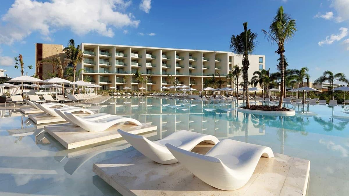 Panoramic view of Grand Palladium Select Costa Mujeres with modern resort buildings, palm trees, and Caribbean coastline