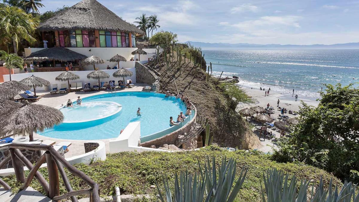 Golden-sand private beach on the Pacific coast near Punta de Mita with loungers and palapa shade
