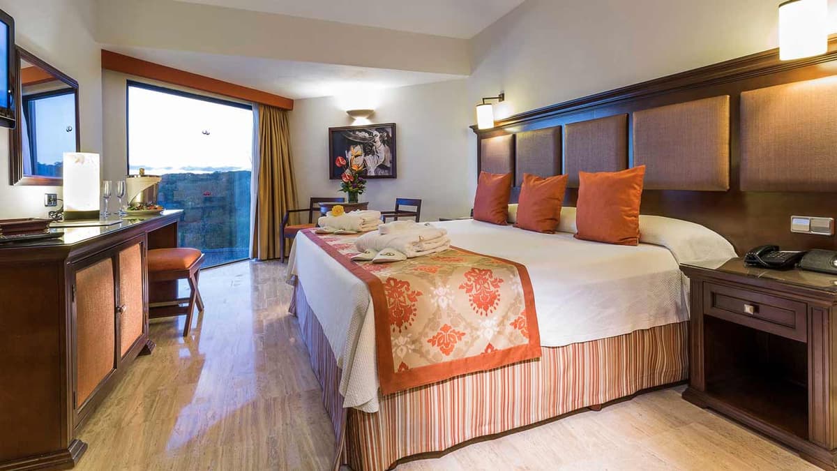 Suite interior with living area, hydromassage bathtub, and ocean views