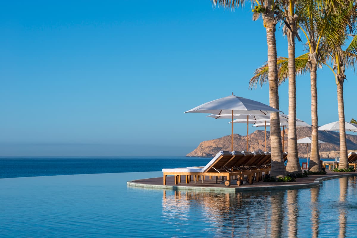Three-tiered infinity pools cascading toward the Sea of Cortez