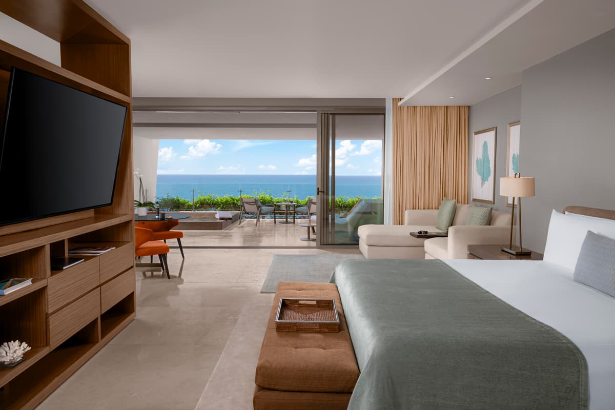 Grand Class Suite bedroom with ocean views and luxury amenities