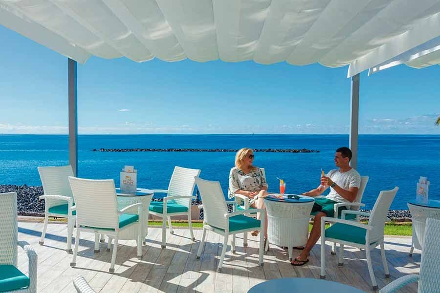 Swimming pool area at Hotel Riu Arecas