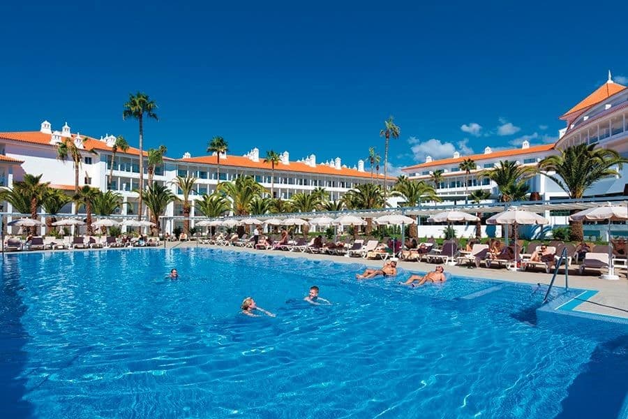 Swimming pool area at Hotel Riu Arecas