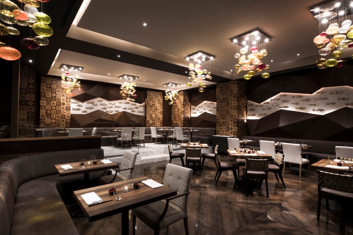 Japanese restaurant interior with dramatic glass chandeliers and fish wall art
