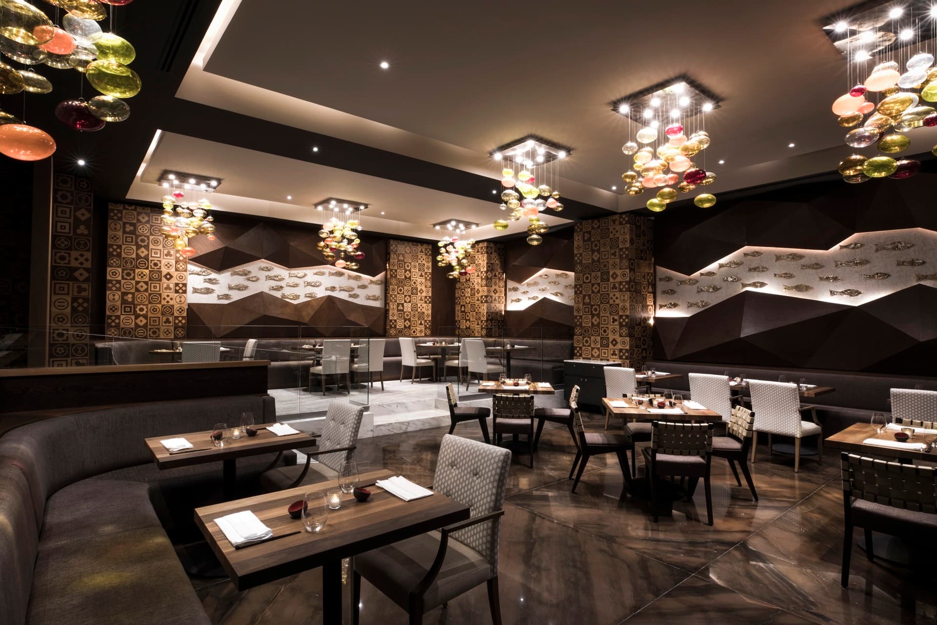 Japanese restaurant interior with dramatic glass chandeliers and fish wall art