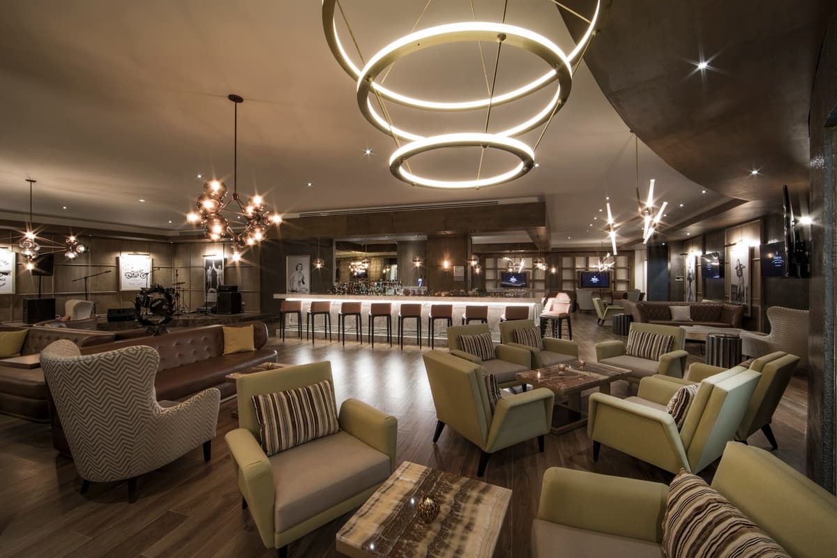 Lounge bar with signature ring light fixtures, live music stage, and sophisticated seating
