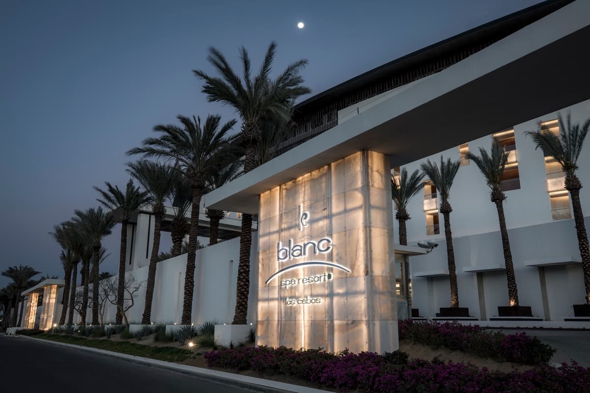 Le Blanc Spa Resort Los Cabos entrance facade illuminated at dusk with signature signage