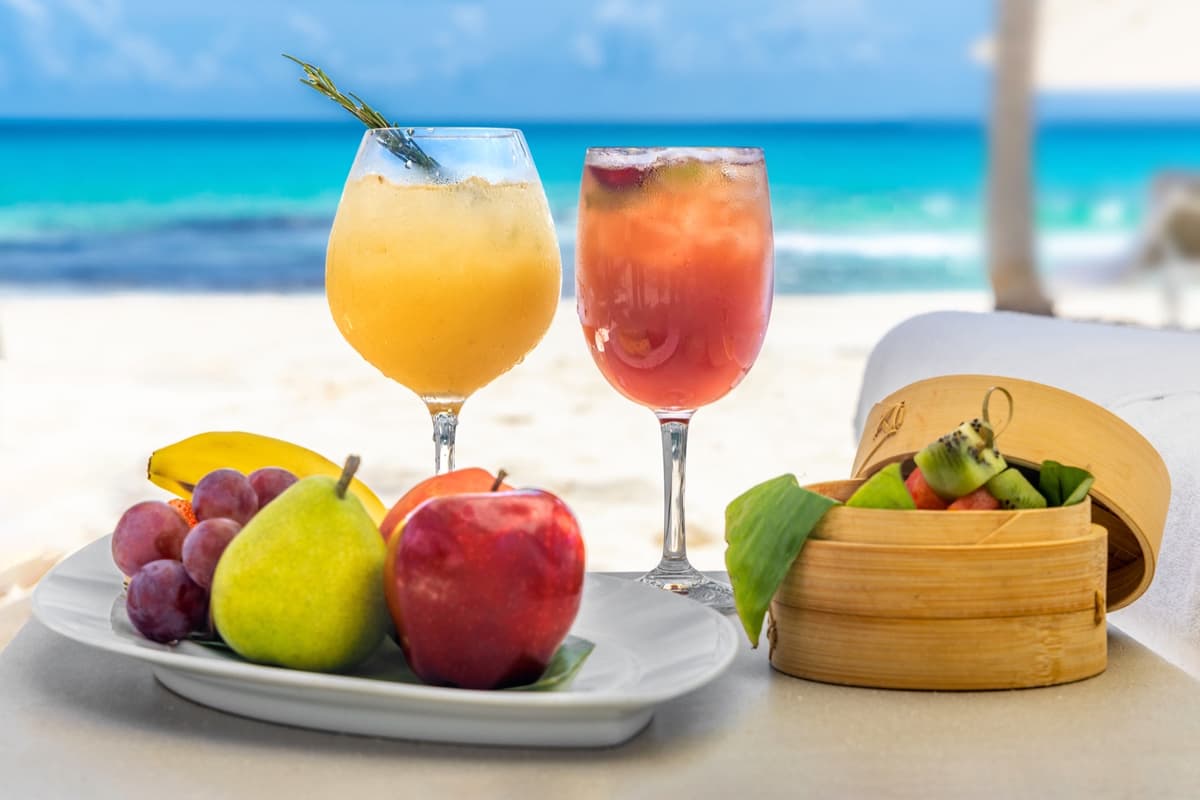Beachside cocktails and fresh fruit service with Caribbean Sea backdrop