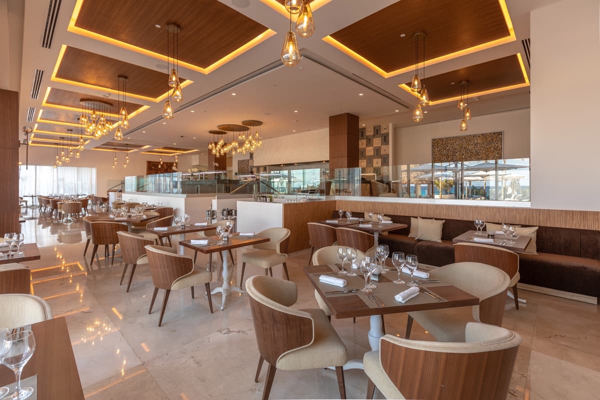 Modern restaurant interior with warm wood ceilings and pendant lighting