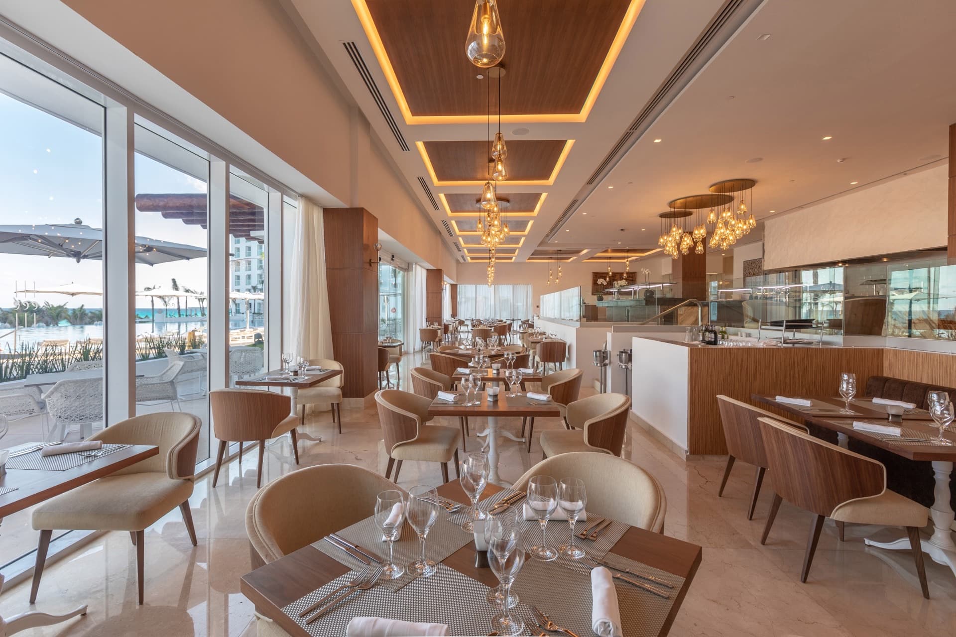 Restaurant with poolside terrace views and elegant table settings