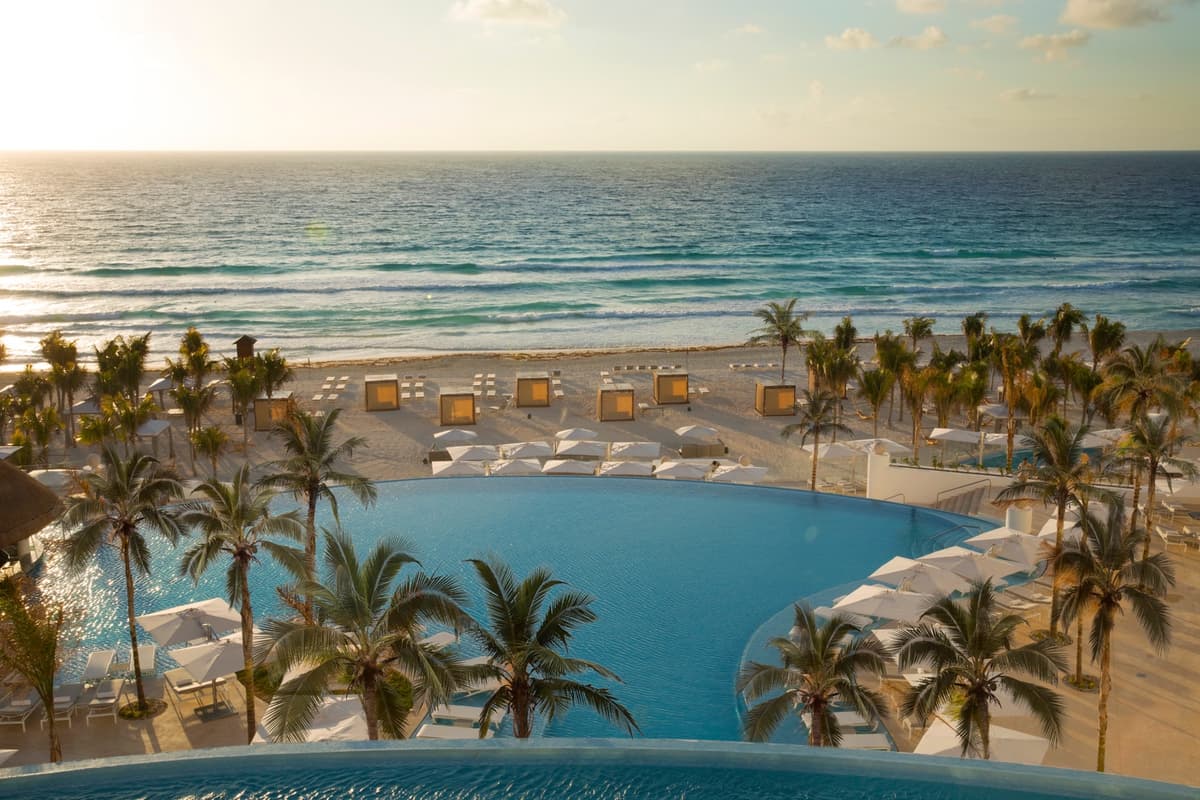 Beachfront pool and white-sand beach at Le Blanc Spa Resort Cancun from above