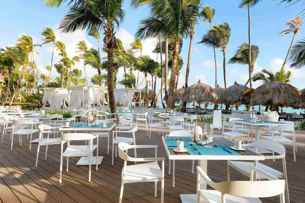 Helios Beach Club terrace — beachfront dining, lounging, and Caribbean views