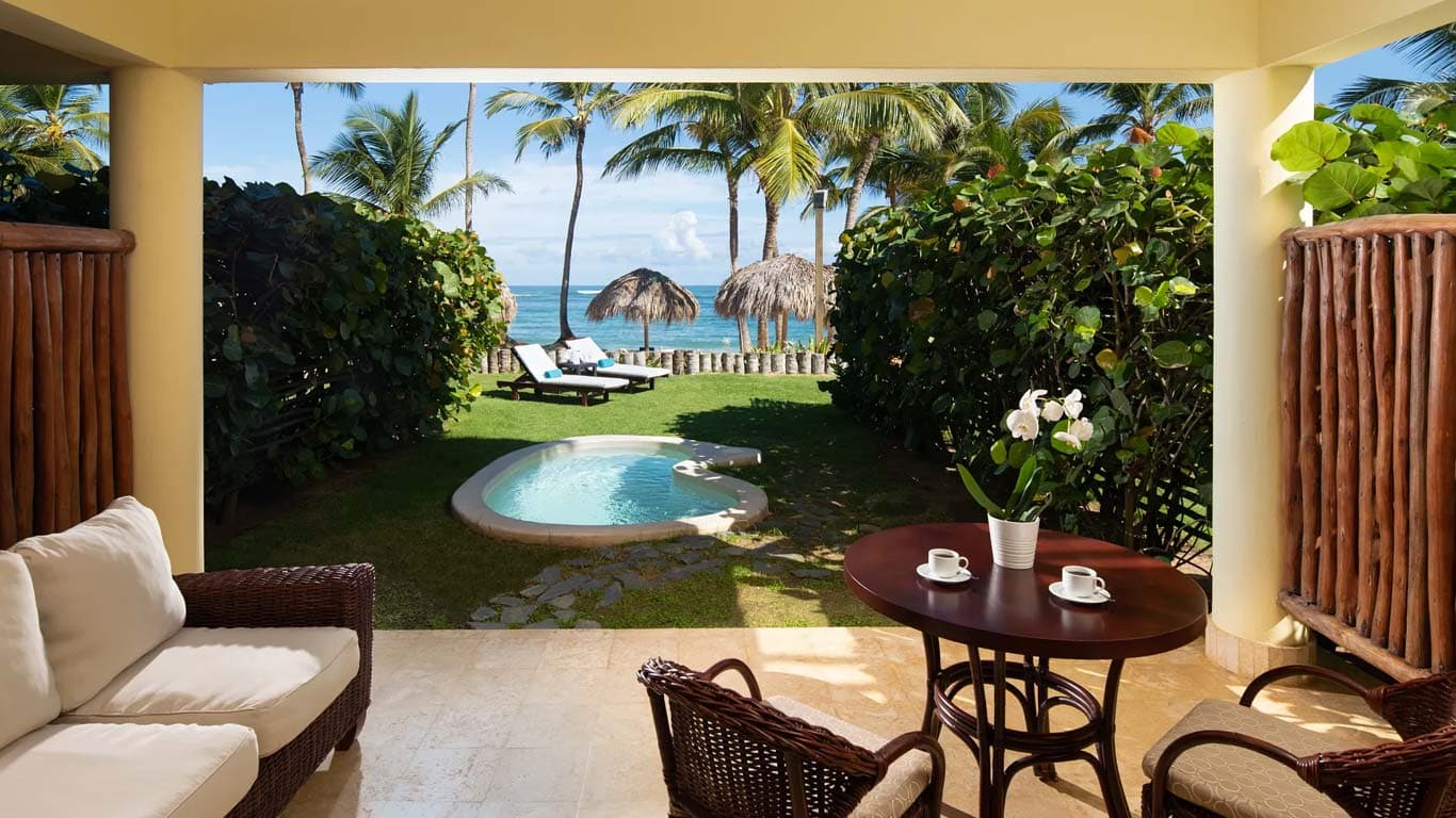 Ocean Front Junior Suite Deluxe terrace with private plunge pool, seating area, and Caribbean ocean views