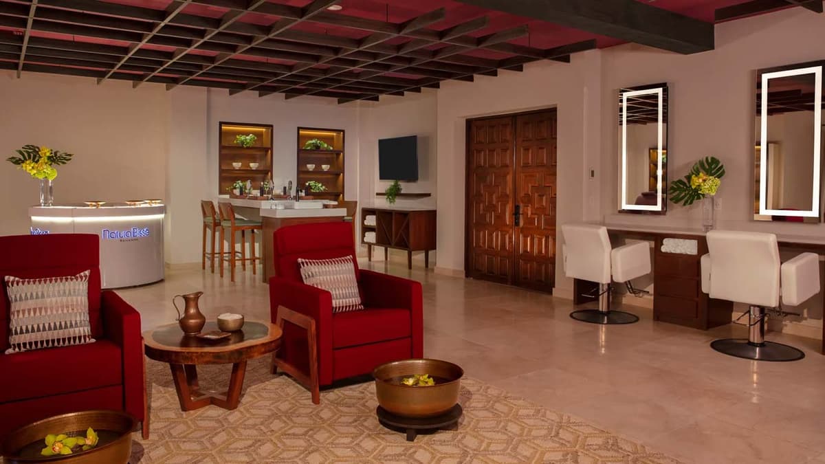 Heated pool area with lounge chairs and tropical landscaping