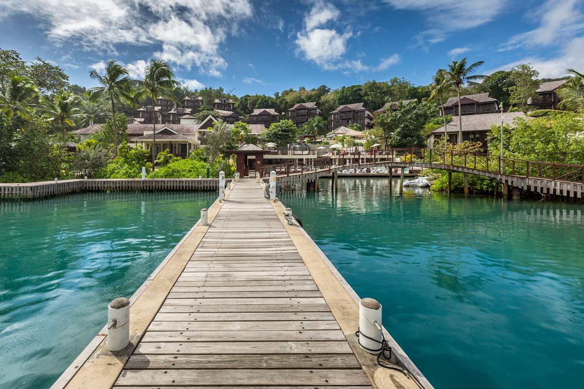 Marigot Bay Yacht Haven marina with luxury yachts anchored beside the resort waterfront boardwalk