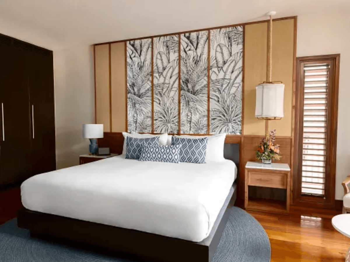 Junior Suite with contemporary Caribbean decor, king bed, cool blue accents, and private balcony