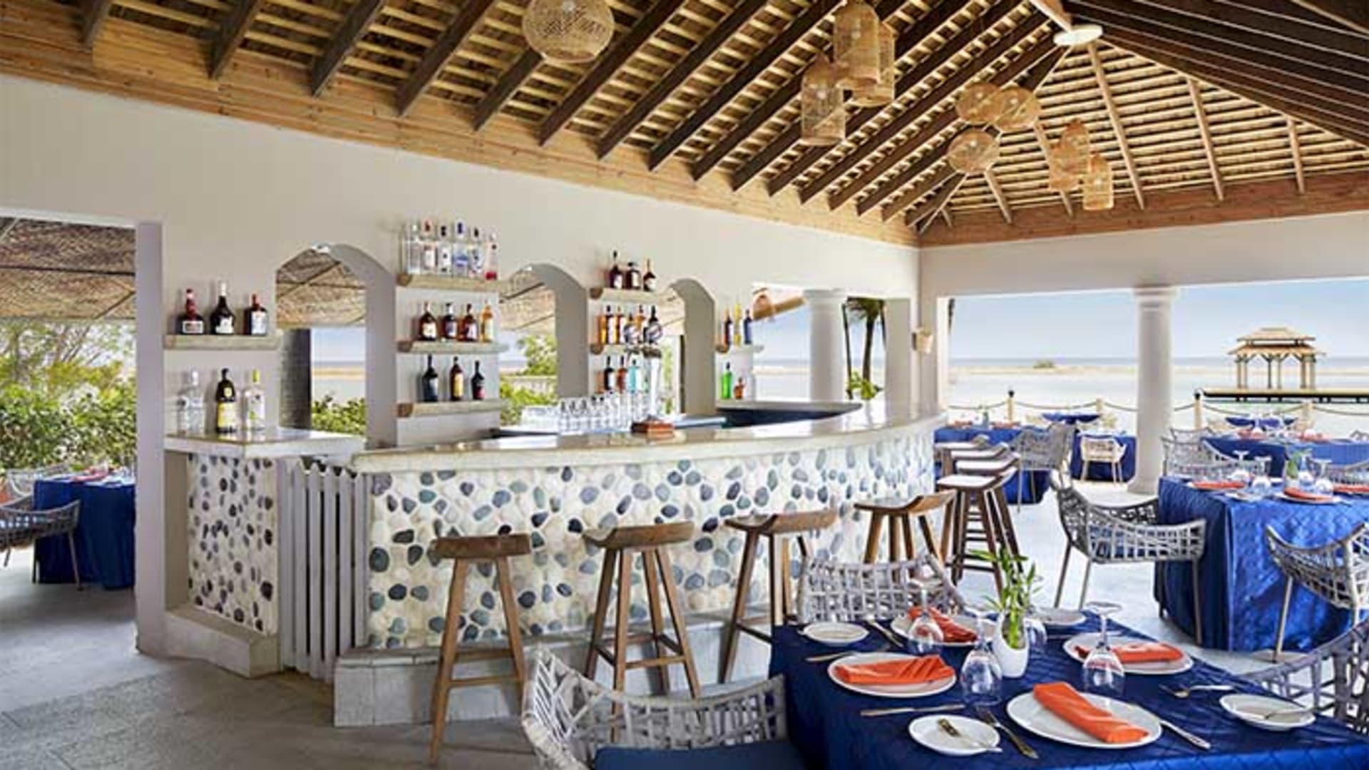 Beachside bar at Zoetry Montego Bay with stone mosaic counter and ocean views