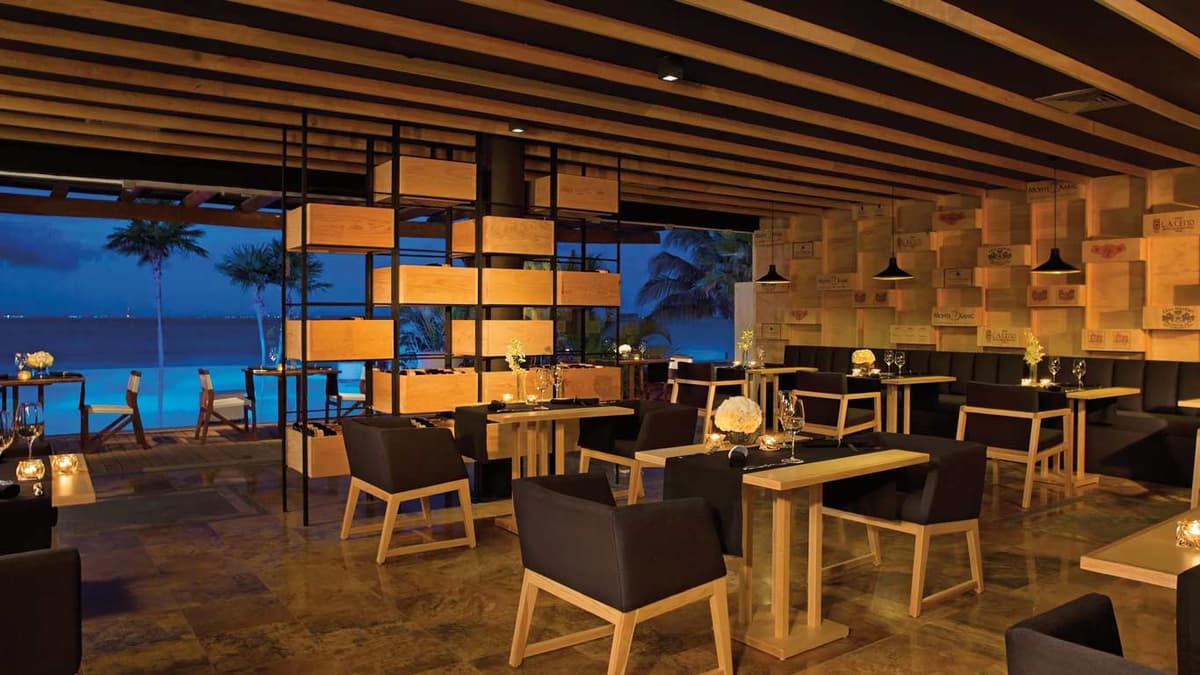 Le Metissage French-Mexican fusion restaurant interior with wine cellar wall and ocean views