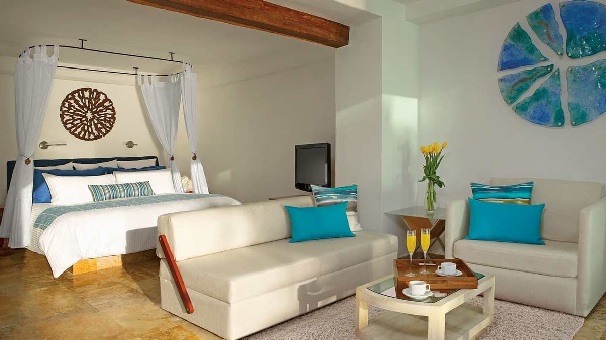 Presidential Suite upper-level bedroom with panoramic ocean views and stained-glass accents