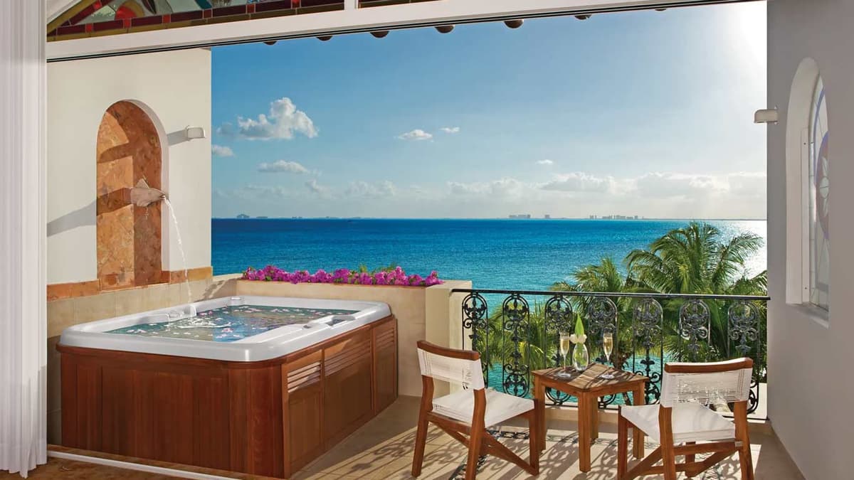 Junior Suite private balcony with two-person hot tub and panoramic Caribbean views