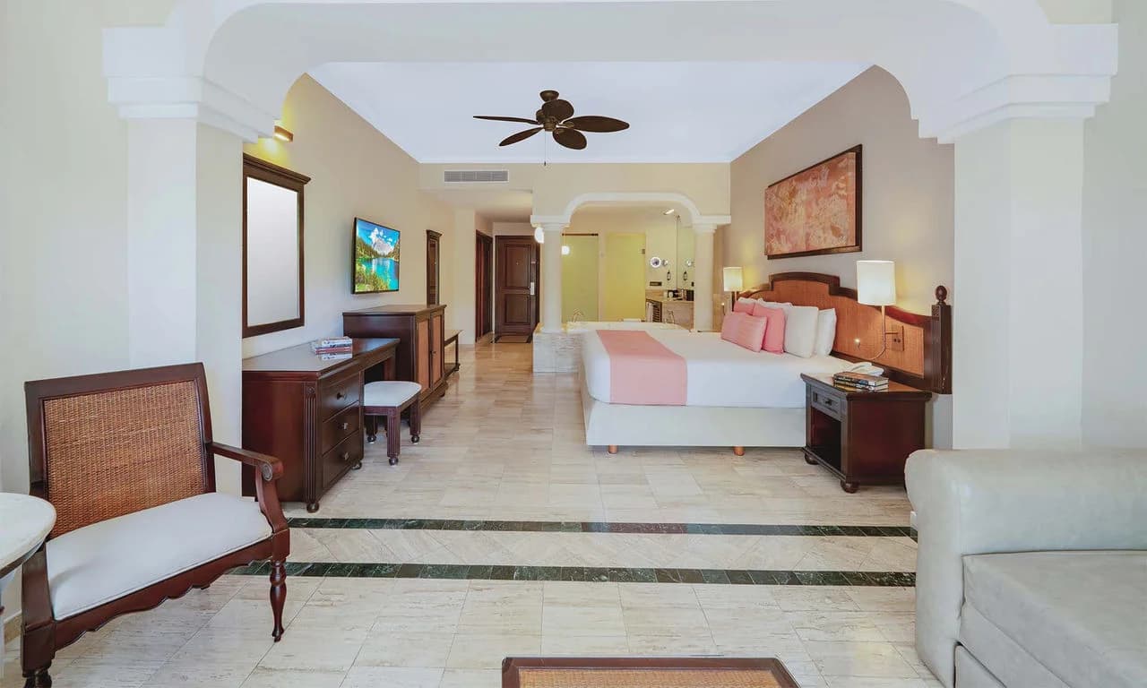 Junior Suite Garden View with king bed and tropical garden terrace