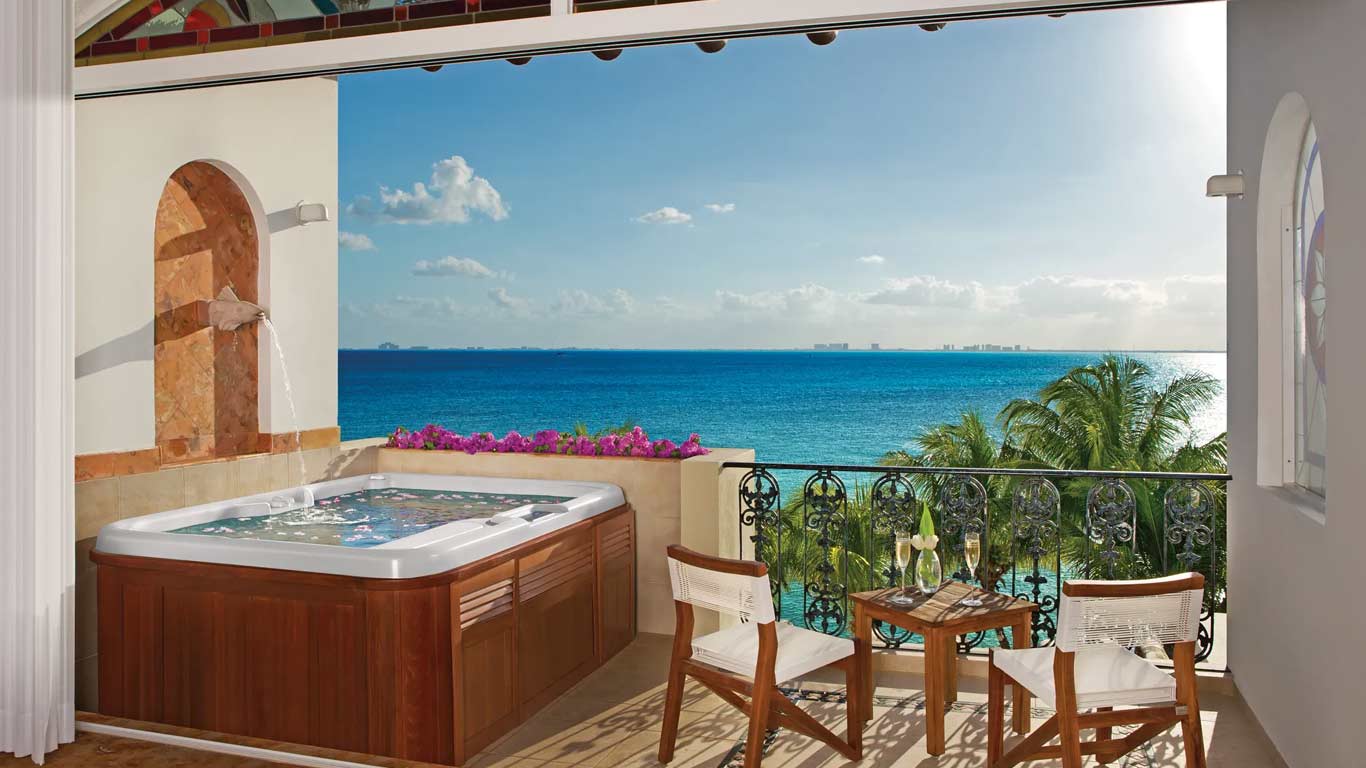 Junior Suite private balcony with two-person hot tub and panoramic Caribbean views