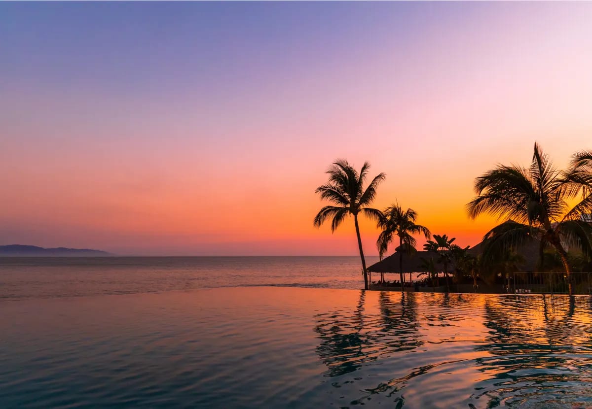 Fitness center with modern equipment and panoramic floor-to-ceiling jungle views