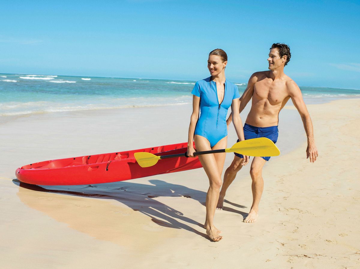 Couples enjoying beach activities on the calm Caribbean waters