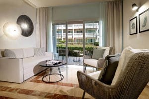 Junior Suite Garden View featuring renovated colonial-style decor, king bed with memory foam mattress, 55-inch TV, and furnished balcony