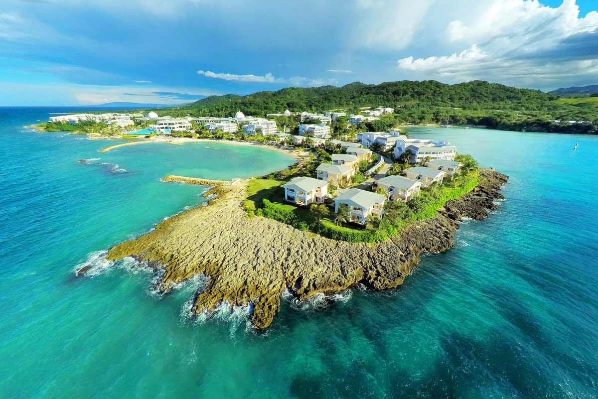 All-inclusive resort experience at Grand Palladium Lady Hamilton showing the Infinite Indulgence program with Caribbean beachfront lifestyle