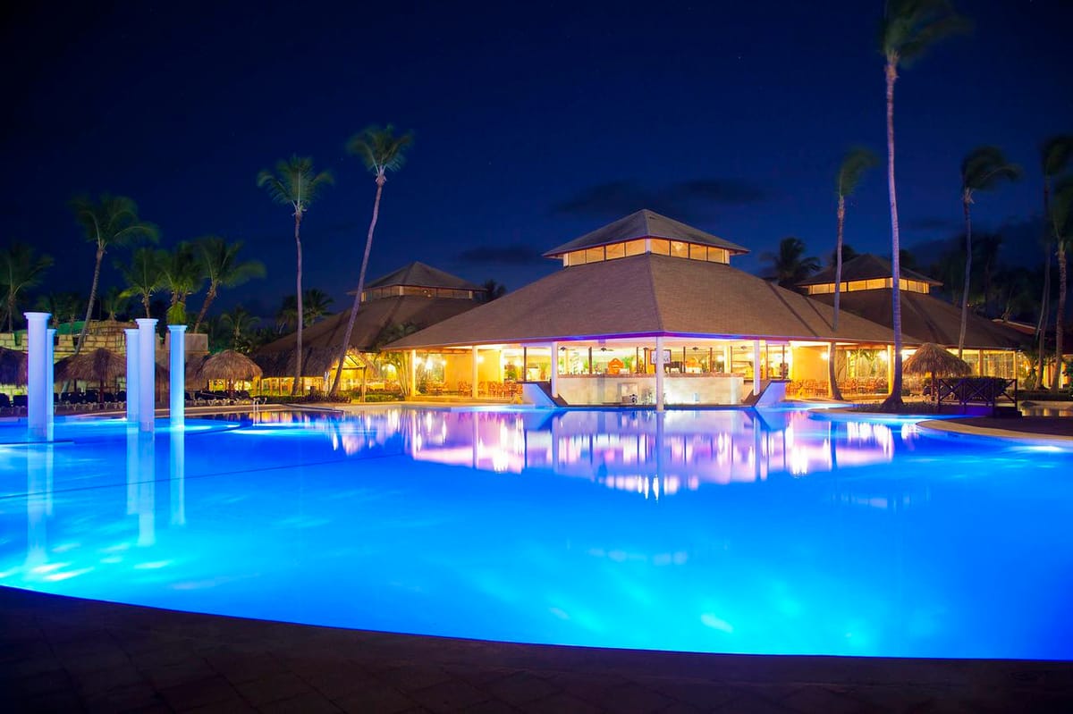 Bavaro Beach at Grand Palladium Palace with fine white sand, turquoise Caribbean waters, and complimentary loungers and umbrellas