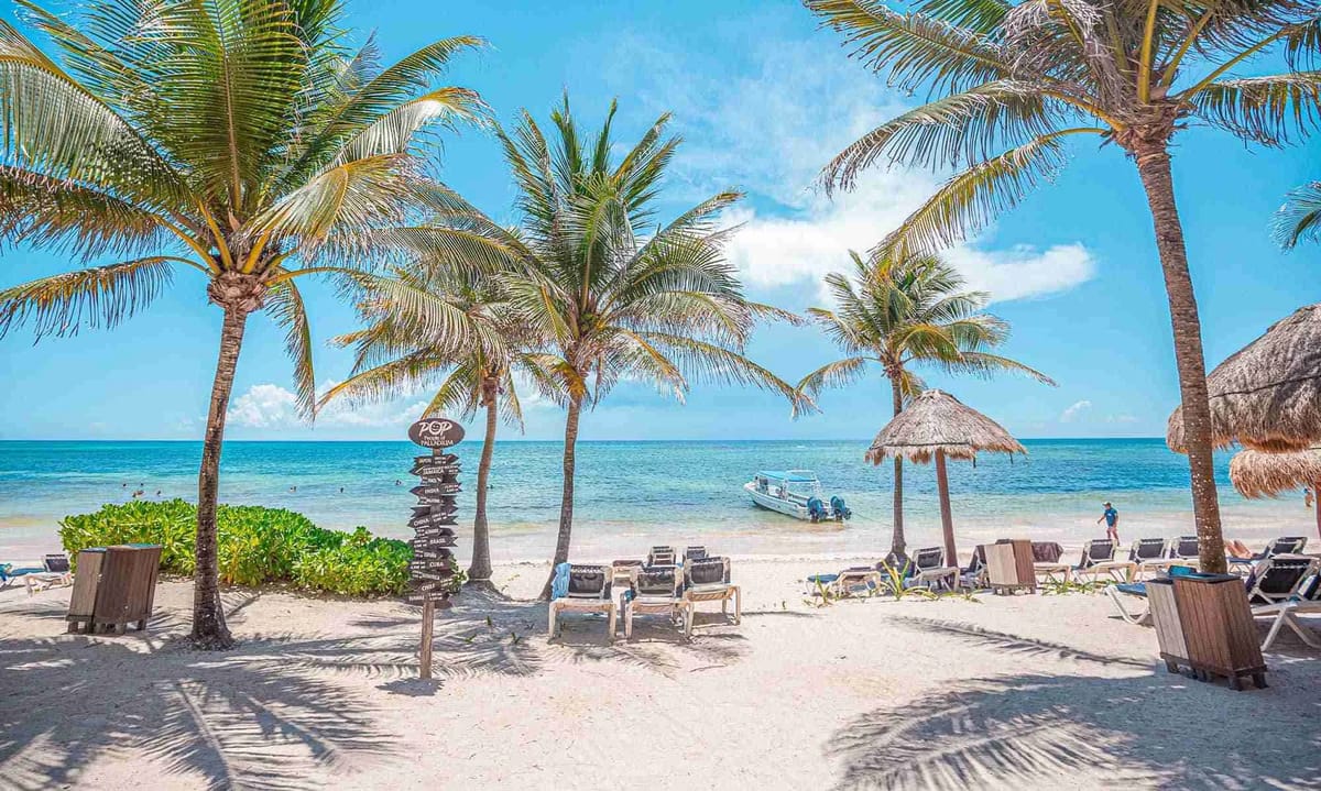 Beach loungers and palapas along the 800-meter Caribbean beachfront