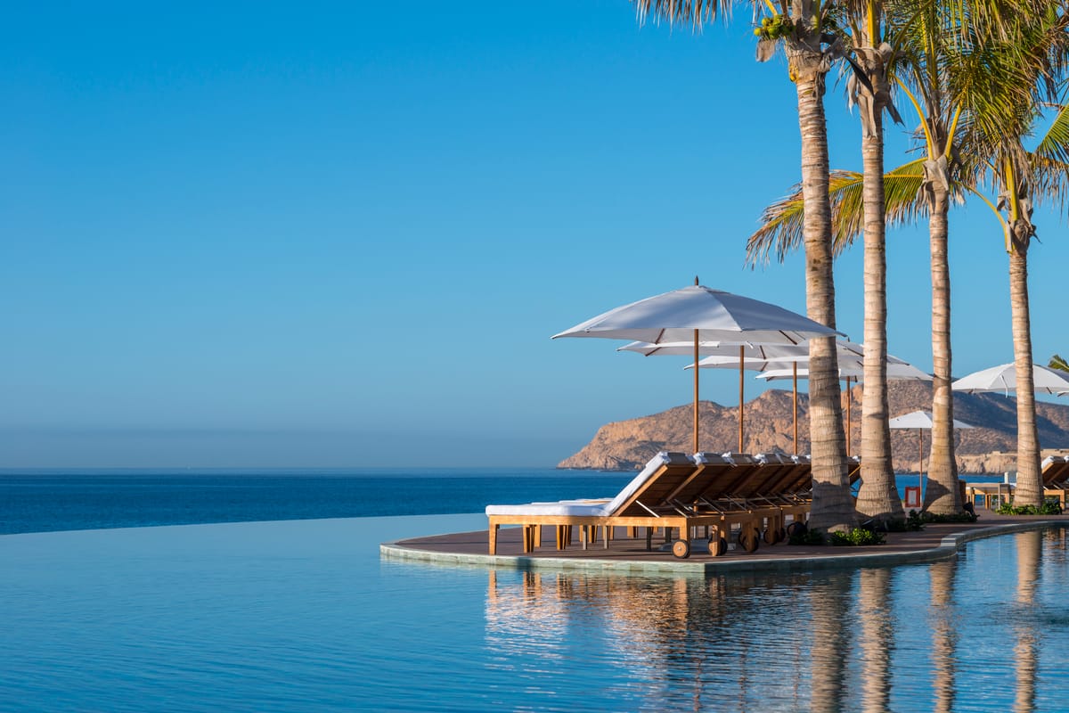 Three-tiered infinity pools cascading toward the Sea of Cortez