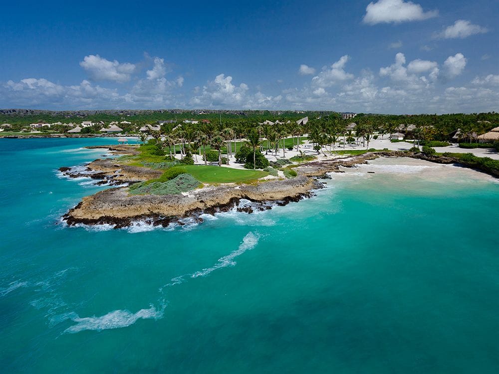 Main swimming pool with swim-up bar and marina views at TRS Cap Cana