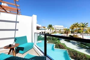 Junior Suite Poolside Ocean View — king bed with modern Mediterranean decor and marina views