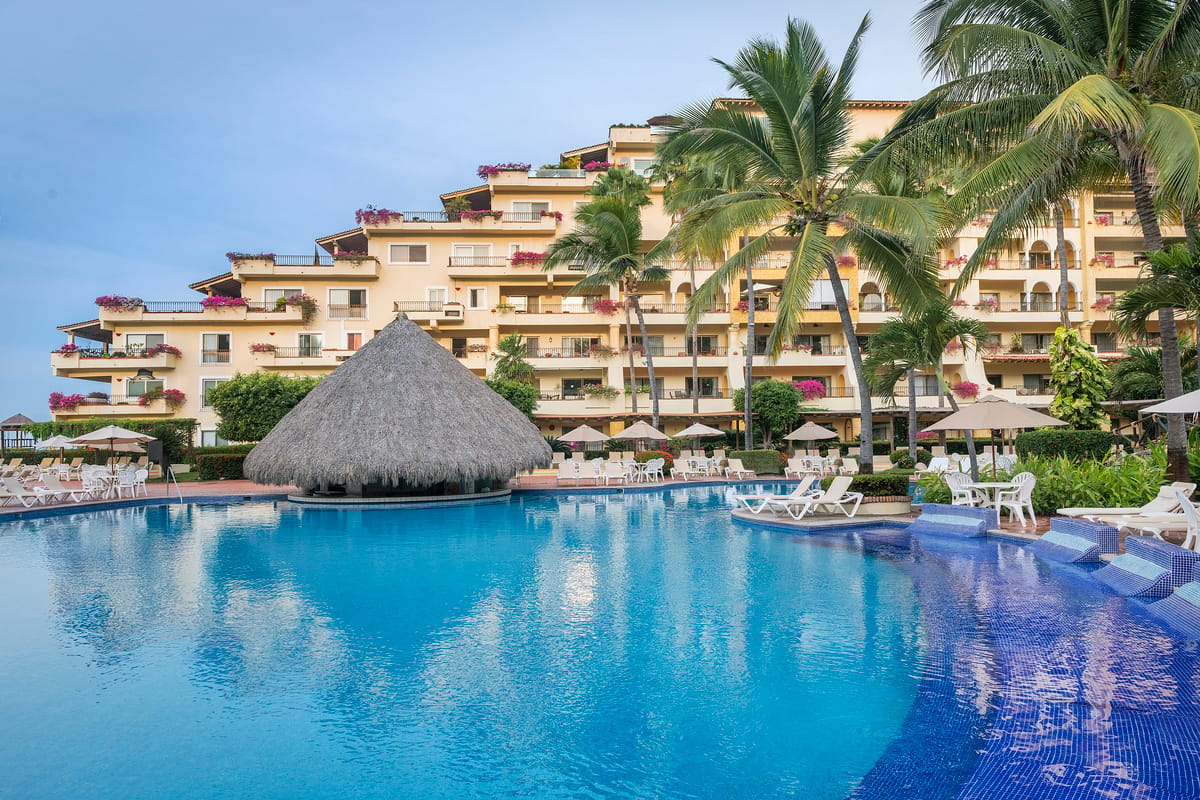 Main pool area with ocean views and palm-fringed lounging deck